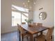 Beautiful dining room featuring wood table, modern chandelier, and large windows at 4037 E Milton Dr, Cave Creek, AZ 85331