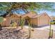 Tan home exterior showcases desert landscaping with drought-tolerant plants, cacti, and rock accents at 4037 E Milton Dr, Cave Creek, AZ 85331