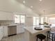 Kitchen featuring an island with breakfast bar, stainless steel appliances, and bright white finishes at 4037 E Milton Dr, Cave Creek, AZ 85331