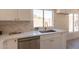 Kitchen sink and countertop area featuring stainless steel appliances, white cabinets and bright natural light at 4037 E Milton Dr, Cave Creek, AZ 85331