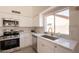 Bright kitchen featuring stainless steel appliances, a large window and modern white cabinetry at 4037 E Milton Dr, Cave Creek, AZ 85331