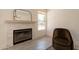 Cozy living area with a fireplace, comfortable chair, and natural light at 4037 E Milton Dr, Cave Creek, AZ 85331