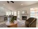 Open living area featuring comfortable seating, fireplace, and access to the dining room and kitchen at 4037 E Milton Dr, Cave Creek, AZ 85331