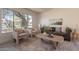 Comfortable living room featuring a gray couch, two chairs, and a large window showcasing the desert landscape at 4037 E Milton Dr, Cave Creek, AZ 85331