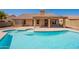 The backyard features a sparkling pool, covered patio, and a seamless transition to indoor-outdoor living at 4037 E Milton Dr, Cave Creek, AZ 85331