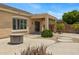 Backyard with covered patio, desert landscaping, and a view of mature plants and a fire pit at 4093 E Westchester Dr, Chandler, AZ 85249