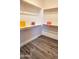 Spacious closet with hardwood floors, white walls, wooden rods, and shelves for optimal storage at 4093 E Westchester Dr, Chandler, AZ 85249