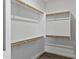 Walk-in closet featuring white walls, wooden rails and shelves providing lots of storage space at 4093 E Westchester Dr, Chandler, AZ 85249