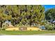 Sun Groves community sign surrounded by lush trees and a tranquil lake offering a peaceful setting at 4093 E Westchester Dr, Chandler, AZ 85249