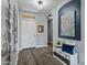 Inviting entryway boasts wood-look floors, a decorative bench, and an artistic wall hanging at 4093 E Westchester Dr, Chandler, AZ 85249