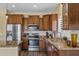 Beautiful kitchen boasts granite countertops, stainless steel appliances, and wood-look flooring at 4093 E Westchester Dr, Chandler, AZ 85249