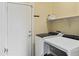 Laundry room with large washer and dryer, shelf and coat hooks at 4093 E Westchester Dr, Chandler, AZ 85249