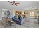 Open concept with wood-look floors flows from living room to kitchen and welcoming entryway at 4093 E Westchester Dr, Chandler, AZ 85249