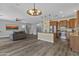 Open-concept living space with hardwood flooring, neutral paint, and stainless steel appliances at 4093 E Westchester Dr, Chandler, AZ 85249