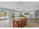 Open-concept living room with views of the pool, a large island, and wood-look flooring at 4093 E Westchester Dr, Chandler, AZ 85249