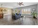 Cozy living room with hardwood flooring, ceiling fan, neutral paint, and bright, sunlit windows at 4093 E Westchester Dr, Chandler, AZ 85249