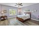 Main bedroom featuring wood-look floors, modern ceiling fan and neutral decor at 4093 E Westchester Dr, Chandler, AZ 85249