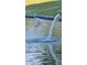 A white crane stands gracefully in a pond where water flows in, enriching the natural landscape at 4093 E Westchester Dr, Chandler, AZ 85249