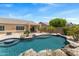 Backyard pool featuring desert landscaping and a built-in table with a view of the covered patio at 4093 E Westchester Dr, Chandler, AZ 85249