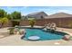 Inviting pool with rock waterfall feature surrounded by desert landscaping in a private backyard setting at 4093 E Westchester Dr, Chandler, AZ 85249