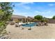 Expansive backyard showcasing a pool with a rock waterfall feature and desert landscaping at 4093 E Westchester Dr, Chandler, AZ 85249