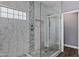Modern bathroom shower featuring decorative tile and a glass enclosure at 4093 E Westchester Dr, Chandler, AZ 85249