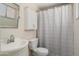 Bathroom featuring a single sink vanity, medicine cabinet, and shower/tub with curtain at 5227 W Acapulco Ln, Glendale, AZ 85306