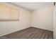 Bedroom featuring wood-look floors and a window with blinds at 5227 W Acapulco Ln, Glendale, AZ 85306