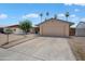 Single story home features a two-car garage, low maintenance landscaping and mature trees at 5227 W Acapulco Ln, Glendale, AZ 85306