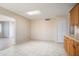 Open eat-in kitchen featuring a skylight, tile flooring, and abundant natural light at 5227 W Acapulco Ln, Glendale, AZ 85306