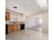 Bright eat-in kitchen with wood cabinets, neutral countertops, and a seamless flow into the adjacent living space at 5227 W Acapulco Ln, Glendale, AZ 85306