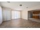 Bright living room featuring wood-look floors, neutral walls, large windows with curtains and sliding door at 5227 W Acapulco Ln, Glendale, AZ 85306