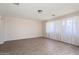 Bright living room showcasing wood-look floors, neutral walls, and large windows with curtains at 5227 W Acapulco Ln, Glendale, AZ 85306