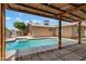 Covered outdoor seating area overlooking a pool and backyard at 5227 W Acapulco Ln, Glendale, AZ 85306