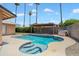 Backyard oasis with pool, covered patio, and lush landscaping perfect for relaxing at 5227 W Acapulco Ln, Glendale, AZ 85306