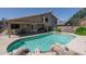 Relaxing backyard with pool including rock waterfall feature, covered patio and mature landscaping at 5596 W Mercer Ln, Glendale, AZ 85304