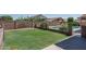 View of backyard's green grass, block wall fencing and partial view of pool at 5596 W Mercer Ln, Glendale, AZ 85304