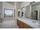 Bright bathroom features a double sink vanity, soaking tub, and a large window at 5596 W Mercer Ln, Glendale, AZ 85304