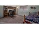 Bedroom with desk, bookshelf, and a bed with patriotic quilt, perfect for work and rest at 5596 W Mercer Ln, Glendale, AZ 85304