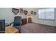 Bedroom setup as office with executive chair and desk with display cabinets at 5596 W Mercer Ln, Glendale, AZ 85304