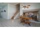 View of dining area with wooden table set, white tiled floors and staircase leading upstairs at 5596 W Mercer Ln, Glendale, AZ 85304