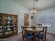 Inviting dining room featuring a round table with seating for four and a display cabinet at 5596 W Mercer Ln, Glendale, AZ 85304