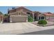Charming home with a multi car garage, tile roof, lush landscaping, and plenty of curb appeal at 5596 W Mercer Ln, Glendale, AZ 85304