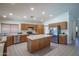 Well-lit kitchen with ample counter space, stainless steel appliances, and tiled flooring at 5596 W Mercer Ln, Glendale, AZ 85304