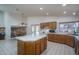 Spacious kitchen with an island, ample counter space, and view to living and dining areas at 5596 W Mercer Ln, Glendale, AZ 85304