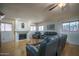 Spacious living room with hardwood floors, fireplace, and comfortable gray leather seating at 5596 W Mercer Ln, Glendale, AZ 85304