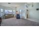 Inviting living room with large windows, neutral carpet, and comfortable seating at 5596 W Mercer Ln, Glendale, AZ 85304