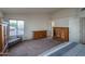 Spacious main bedroom with neutral carpet, bench seating, and wooden dresser at 5596 W Mercer Ln, Glendale, AZ 85304