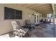 Covered patio featuring stone flooring, exposed beams, seating, and an outdoor grill at 5596 W Mercer Ln, Glendale, AZ 85304