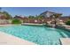 Backyard pool with waterfall, rock features, and lush landscaping for a serene outdoor oasis at 5596 W Mercer Ln, Glendale, AZ 85304